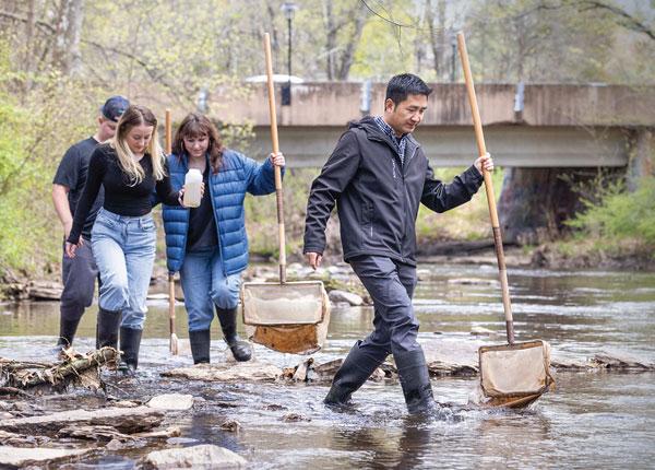 students walking in river
